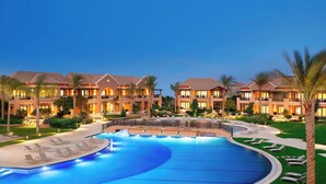 A hotel with a large swimming pool, multiple balconies, and a well-maintained lawn. - The Westin Cairo Golf Resort & Spa, Katameya Dunes (New Cairo)