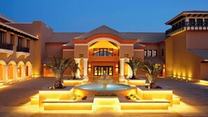 A large, well-lit building with a central fountain, multiple balconies, and a symmetrical design. - The Westin Cairo Golf Resort & Spa, Katameya Dunes (New Cairo)
