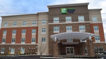 A Holiday Inn Express hotel with a modern facade, multiple windows, and a covered entrance.