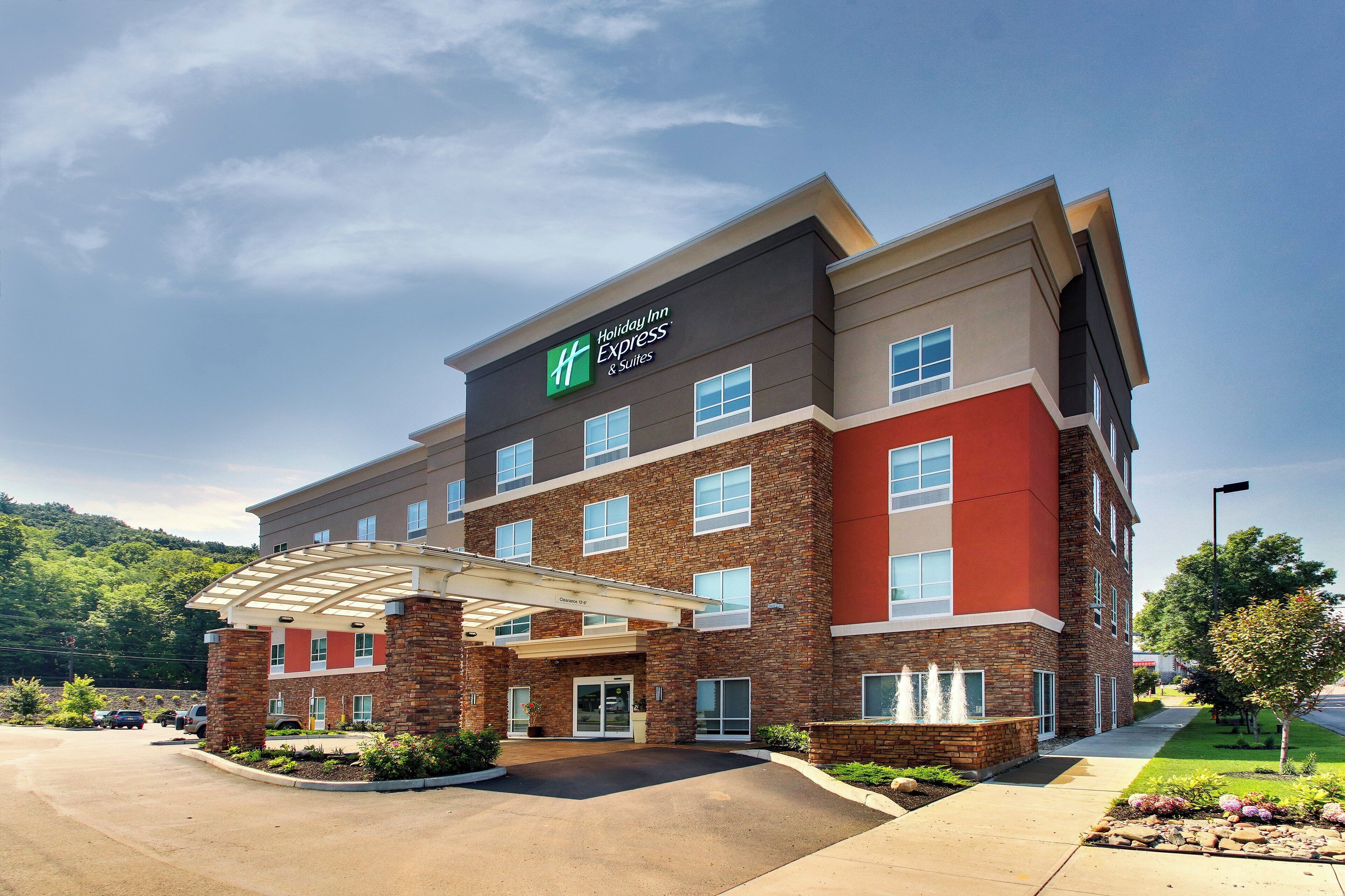 A Holiday Inn Express building with a covered entrance, brick facade, and multiple windows.