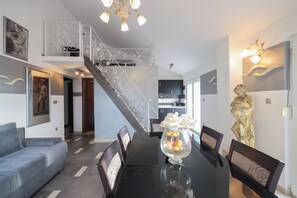 Apartamento Deluxe, 2 habitaciones | Zona de estar | Una televisión, una mesa de tenis de mesa