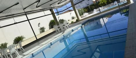 Indoor pool, outdoor pool, open 6 AM to 10 PM, pool umbrellas