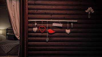A wooden wall with a hanging heart-shaped decoration and a sign that reads "This is your happy place."
