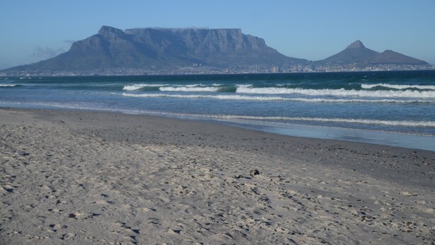 A beach with a mountain in the background. - Atlantic Breeze (Cape Town)