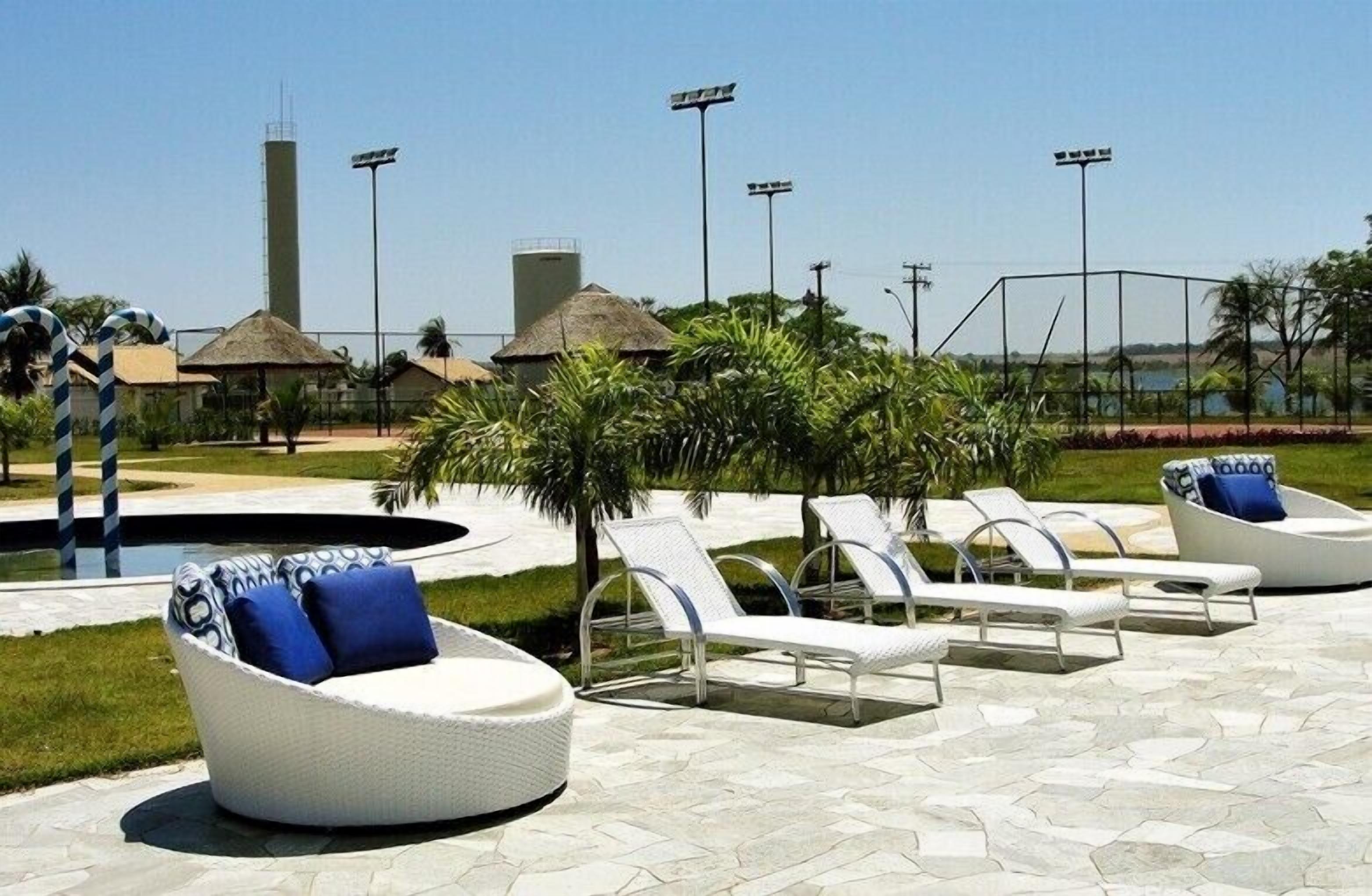 A poolside area with lounge chairs, a small pool, and a water tower in the background.
