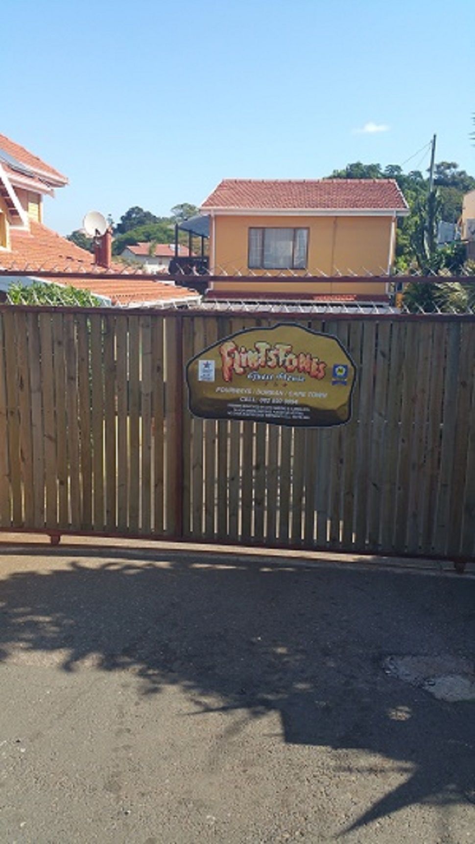 A gated entrance with a sign for 'Firestone's' restaurant.