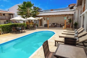 Outdoor pool, open 9:00 AM to 7:00 PM, pool umbrellas, pool loungers