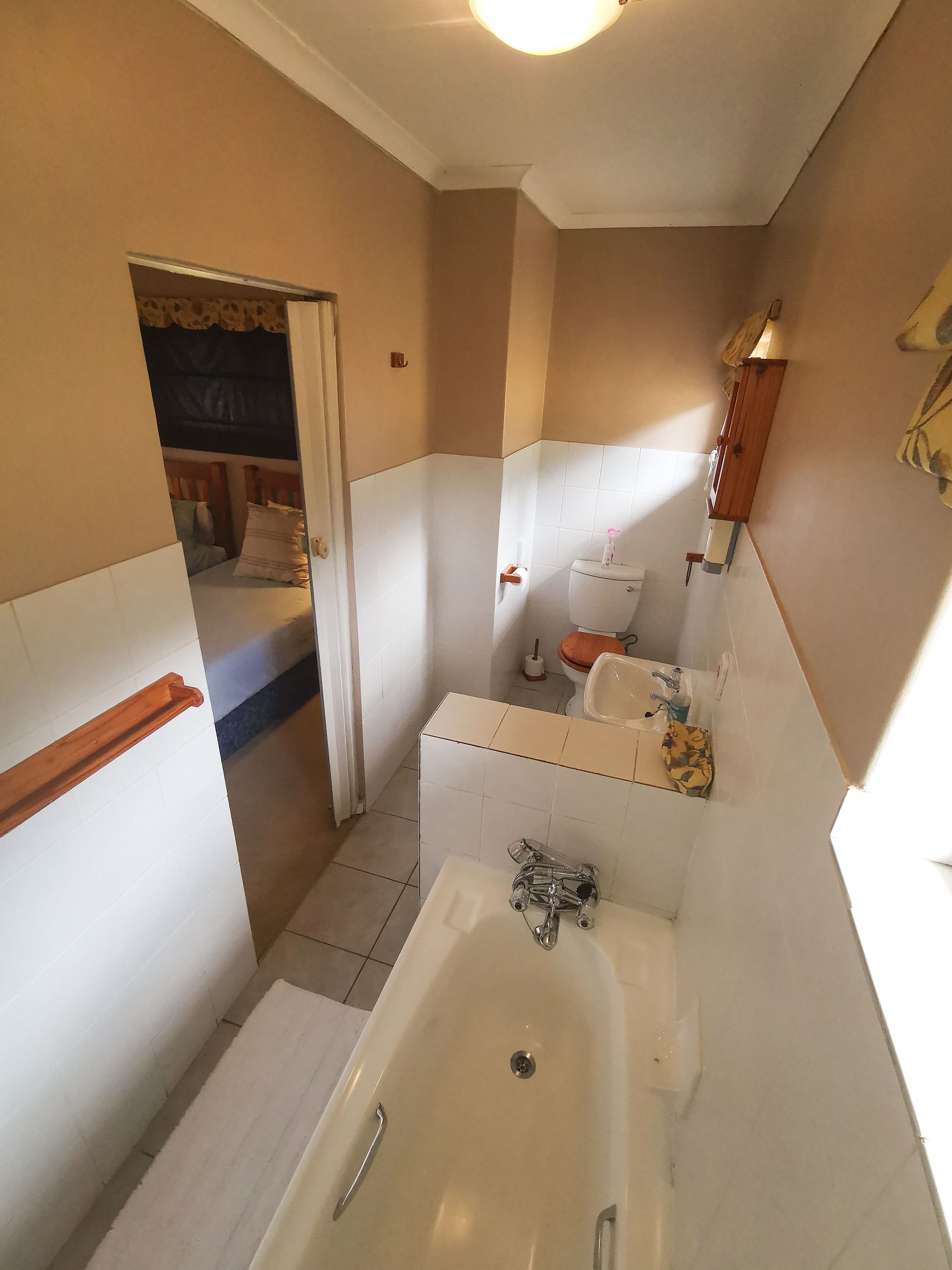 A bathroom with a bathtub, toilet, and sink.
