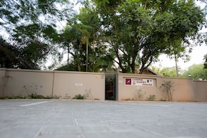 A parking area with a building labeled "LOERIE GUEST HOUSE" and a sign indicating "PARKING" to the left.