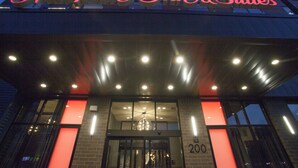 The exterior of Hampton Inn & Suites with illuminated signage, a glass entrance, and a number '200' on the building facade. - Hampton Inn & Suites Downtown St. Paul (St. Paul)
