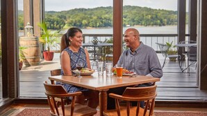 A couple dining at a table with a scenic lake view. - Lake Barkley State Resort (Cadiz)