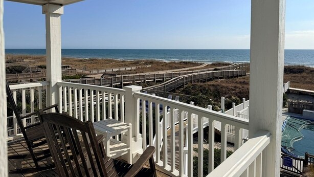 A covered outdoor area with a view of the beach and ocean. - Majak Moments 7 Bedroom Home by RedAwning (Supply)