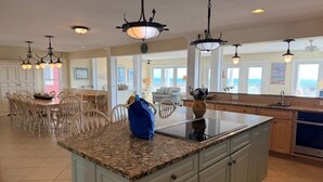 A spacious kitchen with granite countertops, a central island, and pendant lighting. - Majak Moments 7 Bedroom Home by RedAwning (Supply)