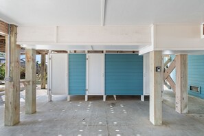 A room with a concrete floor, wooden beams, and a blue door. - Majak Moments 7 Bedroom Home by RedAwning (Supply)