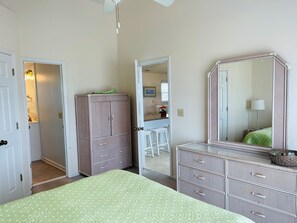 Cozy retreat with a large bed, wardrobe, and dresser, perfect for a comfortable stay.