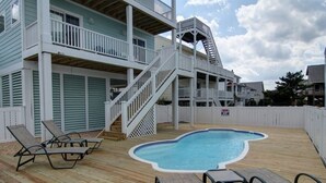 A multi-level building with a swimming pool, outdoor seating, and a staircase. - Welcome  4 Bedroom Home by RedAwning (Supply)