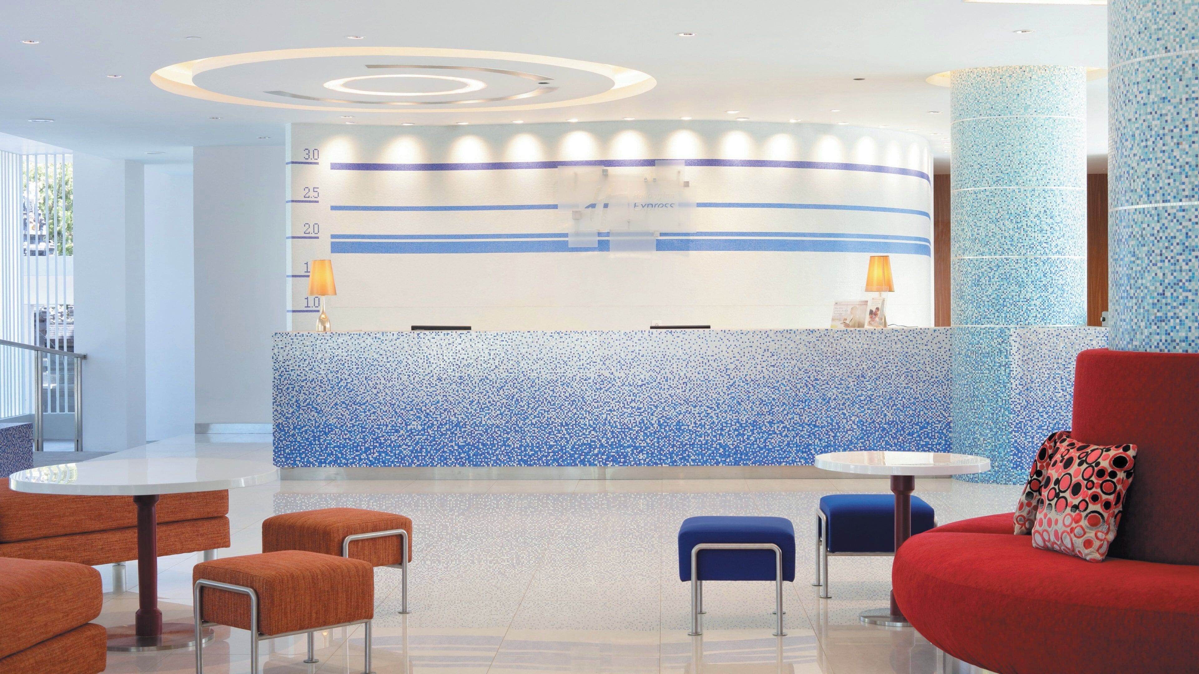 A reception area with a counter, seating, and a decorative wall.