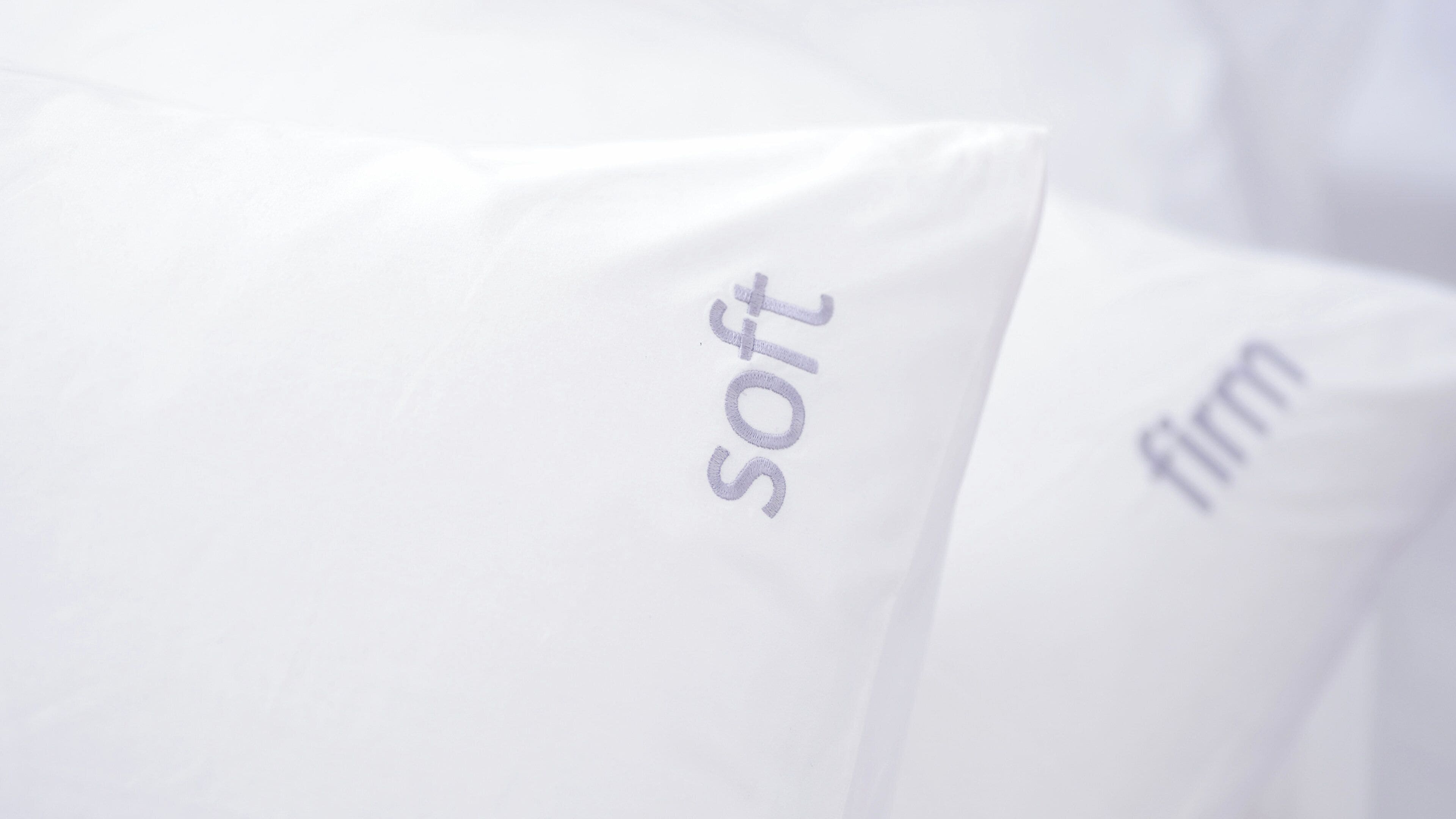 Pillows with embroidered text.