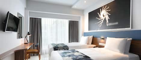 A modern hotel room with two beds, a desk, a chair, a flat-screen TV, and a large abstract painting.