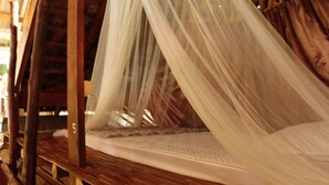 A wooden bed with a canopy, a visible mattress, and a number '5' on the headboard. - UP2U Guesthouse - Hostel (Pai)