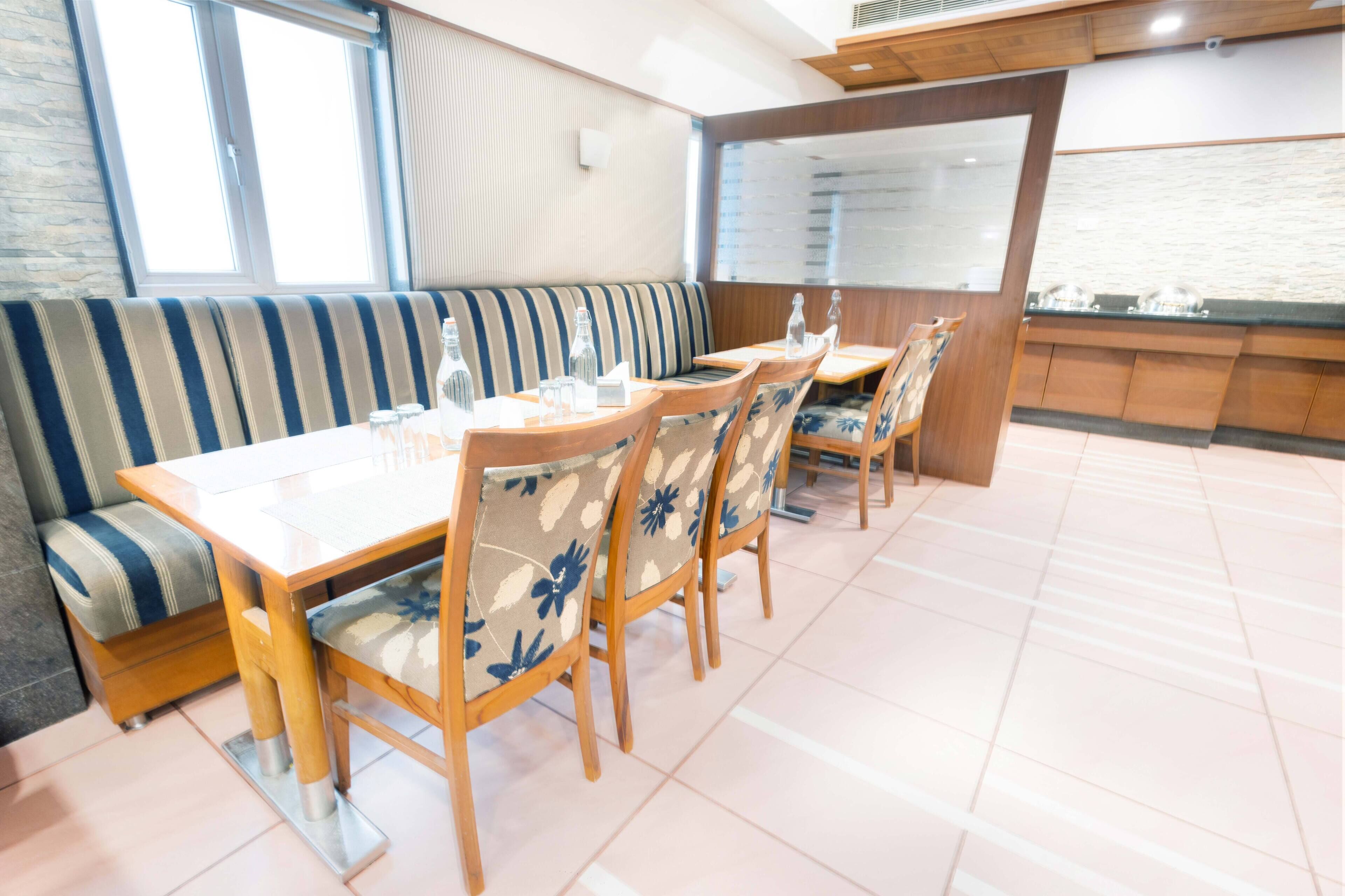 A dining area with a long table, chairs, and a bench.