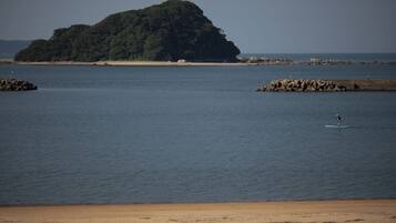 Enjoy paddleboarding and taking in the serene views of the nearby island from this beautiful beach.