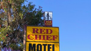 A motel sign with a mascot and the name 'Red Chief'.