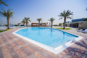 2 outdoor pools, open 8:00 AM to 11:00 PM, pool umbrellas, pool loungers