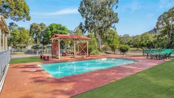 Seasonal outdoor pool, open 10:00 AM to 8:00 PM, pool loungers