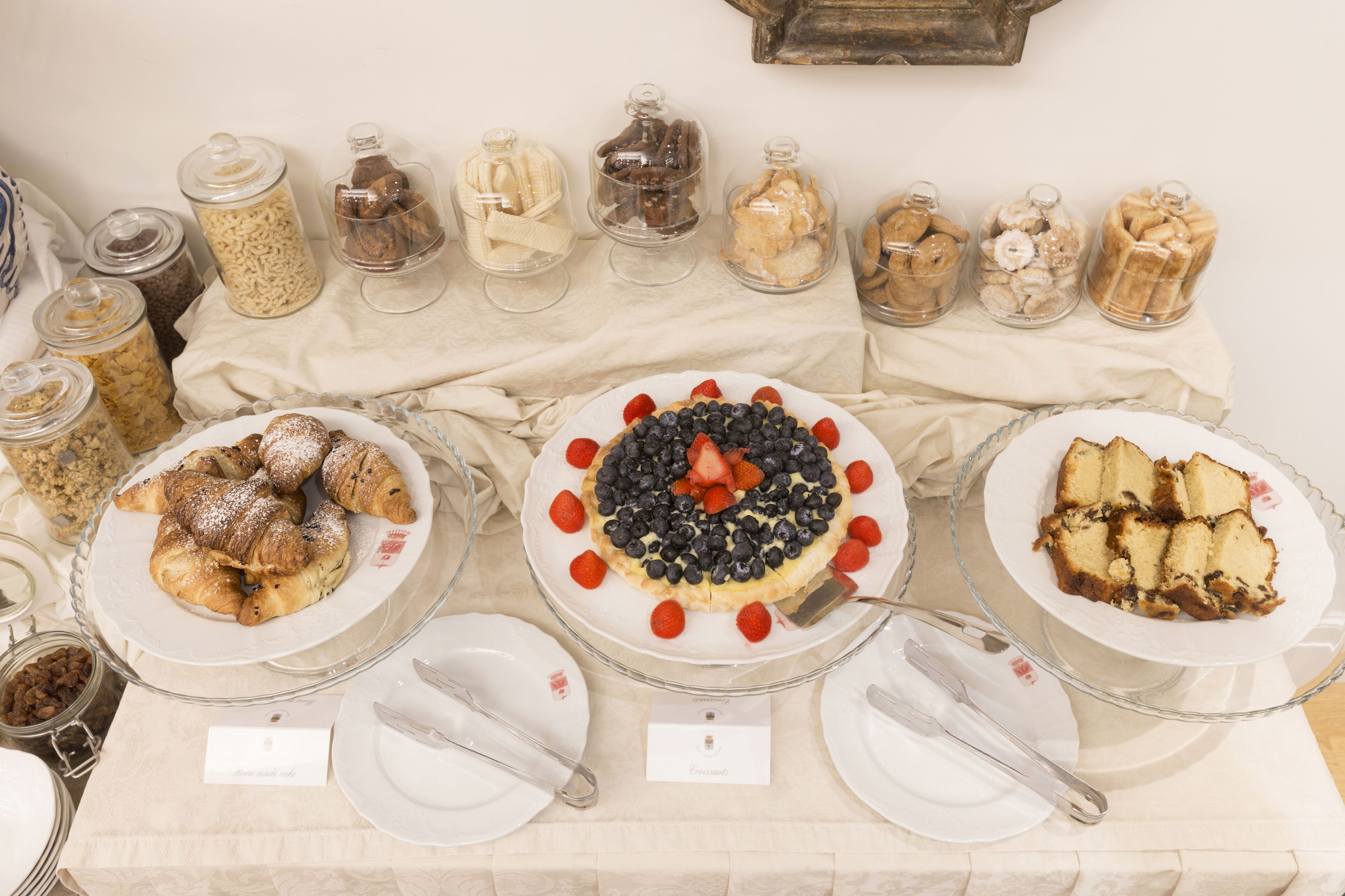 A buffet table with various food items and serving utensils.