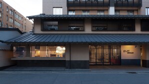 A hotel with a modern facade, large windows, and a visible entrance.