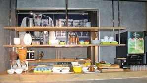 A buffet setup with various food items and utensils. - ibis budget Chambéry Sud Challes les Eaux (Challes-les-Eaux)