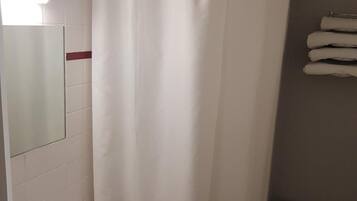 A bathroom with a white sink, a toilet, and a shower curtain.