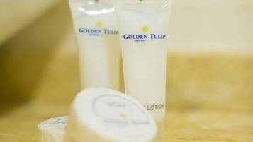Two tubes of Golden Tulip lotion and a round container on a marble surface.