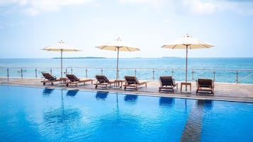 Outdoor pool, open 7:00 AM to 7:00 PM, pool umbrellas