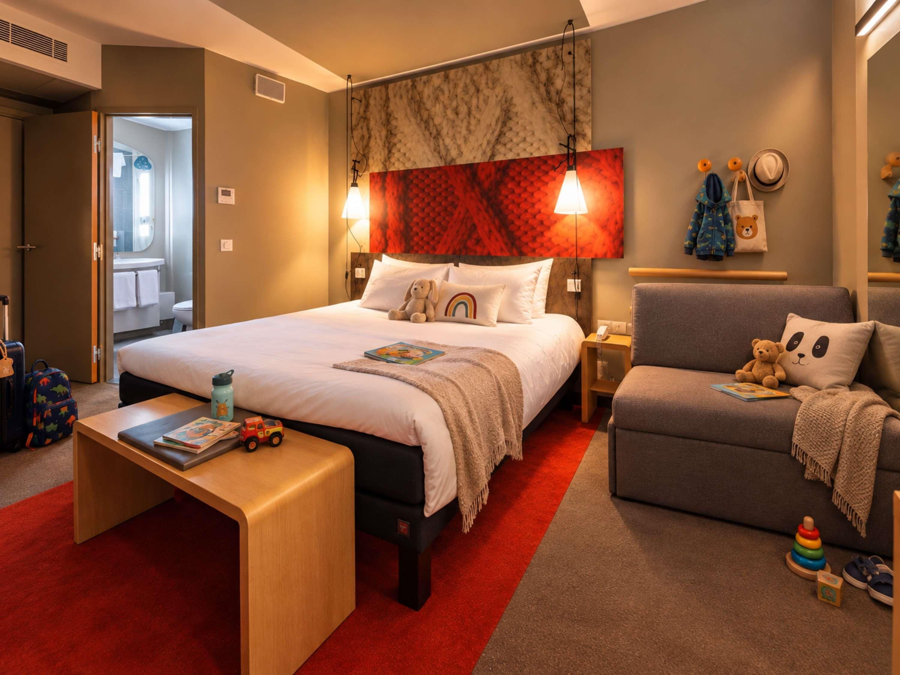 A hotel room with a bed, bedside table, chair, and a red carpet.