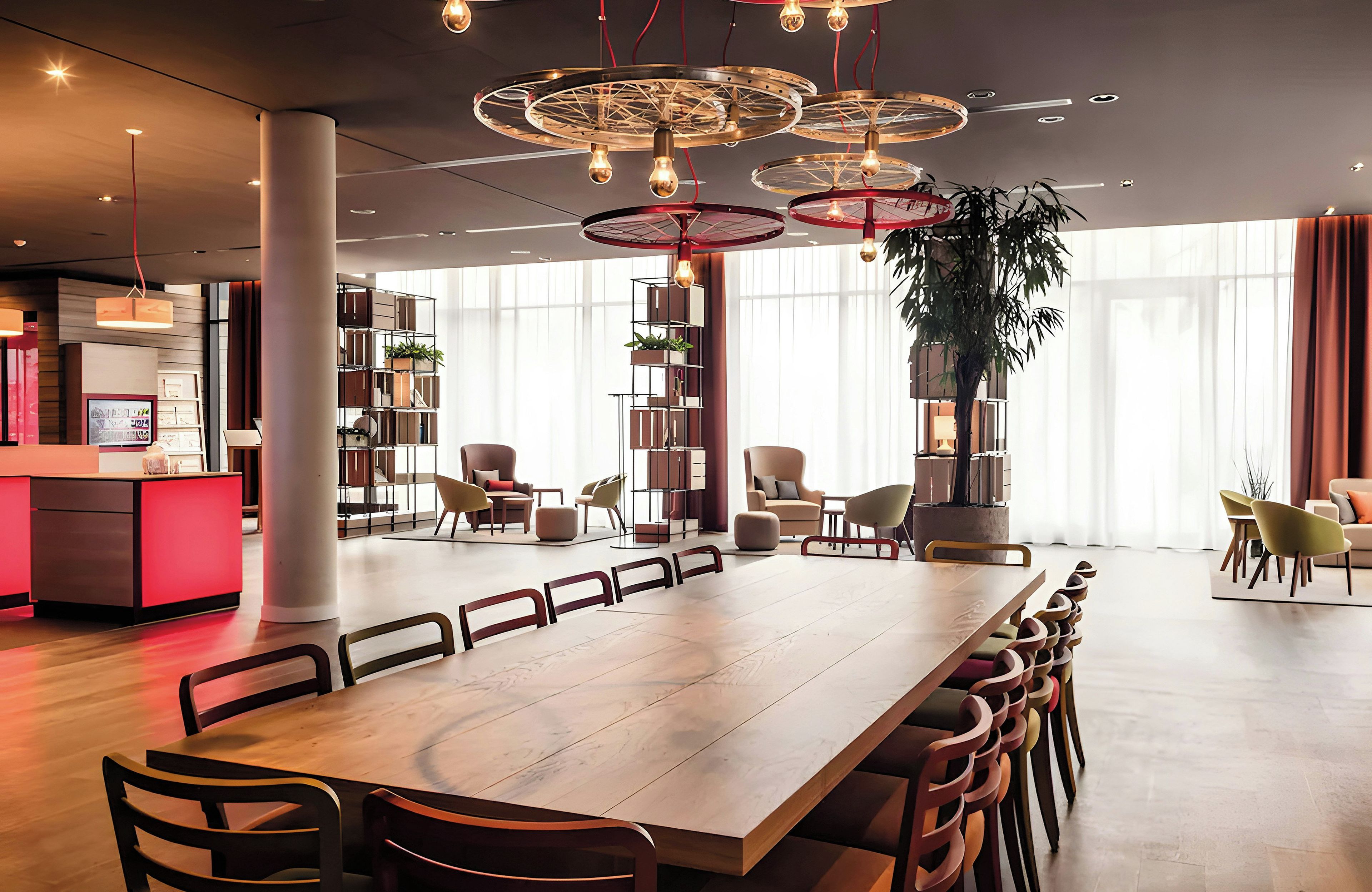 A modern dining area with a long wooden table, multiple chairs, and a unique ceiling light fixture.