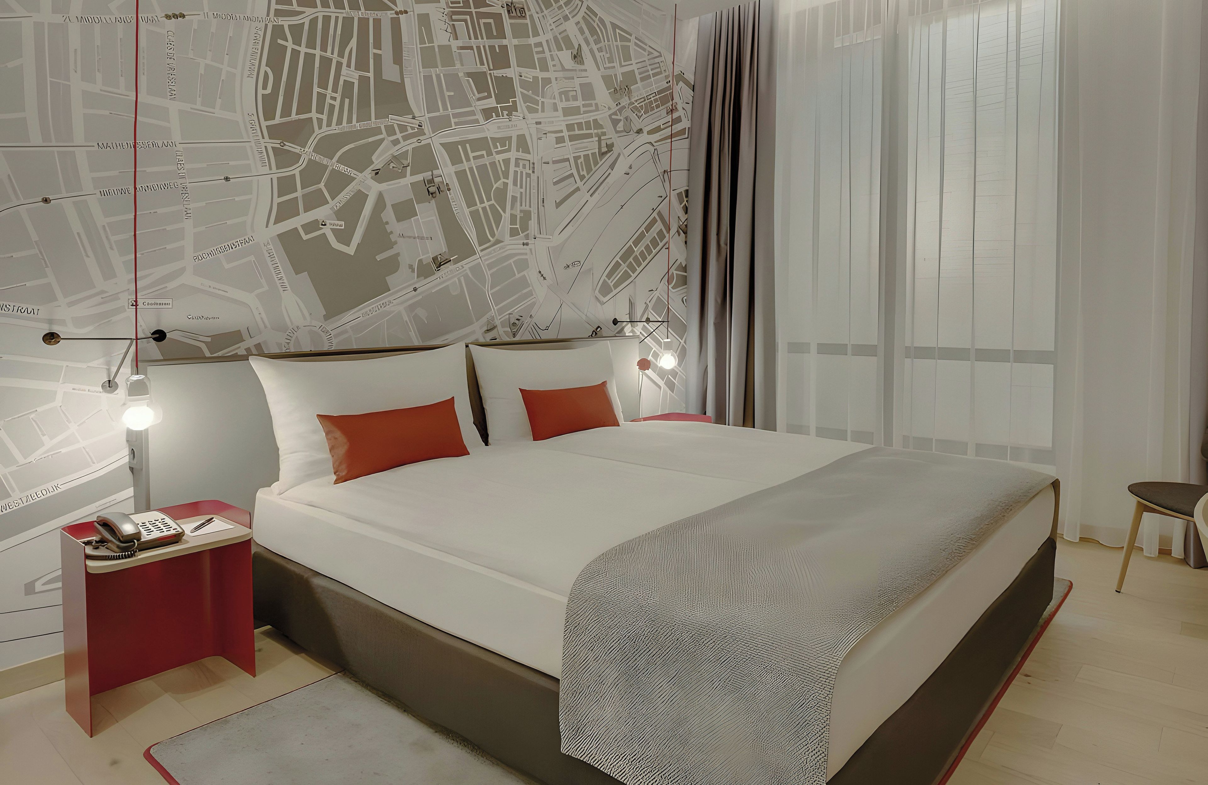 A modern bedroom with a large bed, a nightstand, a map wall, and a window with curtains.