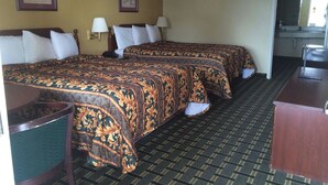 A hotel room with two beds, a desk, a chair, and two wall-mounted lamps. - Executive Inn & Suites Schulenburg (Schulenburg)