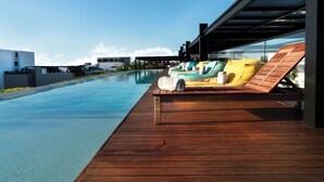 A wooden deck with lounge chairs and a pool. - Fiesta Inn Playa del Carmen (Playa del Carmen)
