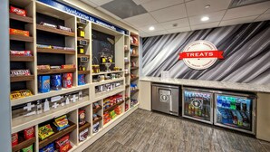 A snack and drink display area with various packaged snacks and beverages. - Hampton Inn Summerville SC (Summerville)