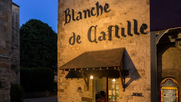 A stone building with a sign reading "Blanche de Caffille".