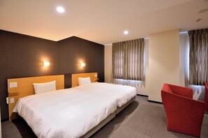 A hotel room with a large bed, two bedside tables, a red chair, and a window with curtains. - Hotel Urbic Kagoshima (Kagoshima)