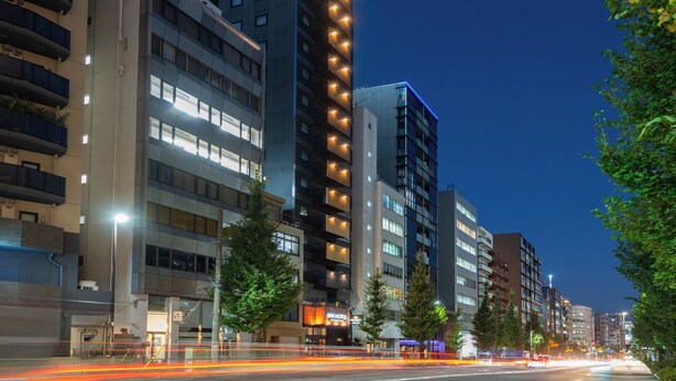 A multi-story hotel with a prominent 'APA' sign on the top, featuring a modern architectural design with balconies and large windows. - APA Hotel Ochanomizu Ekikita (Tokyo)