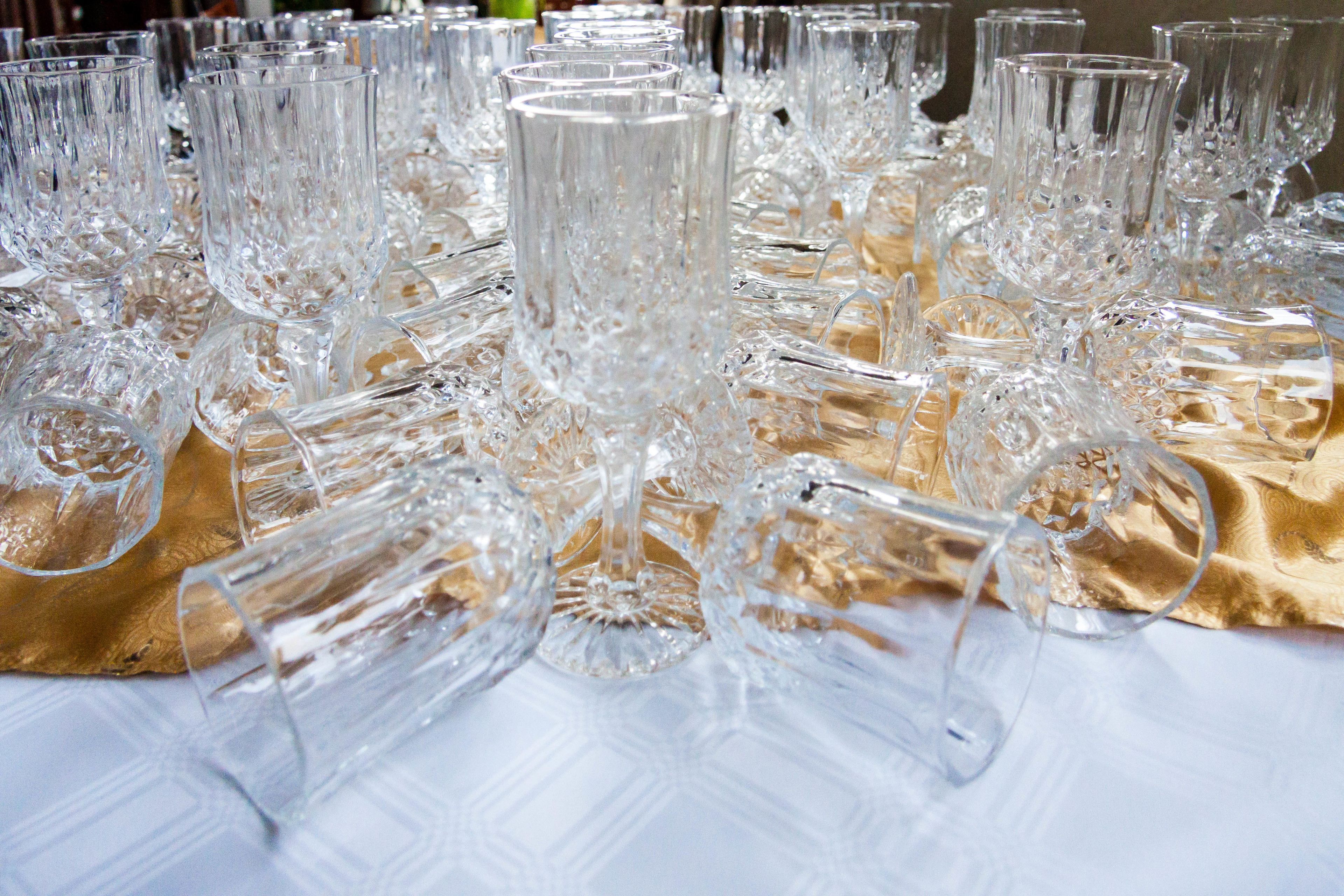 A table covered with numerous clear, intricately designed glasses.