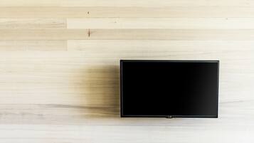 A flat-screen TV on a light wooden floor.