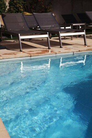 Seasonal outdoor pool, open 10:00 AM to 10:00 PM, pool umbrellas
