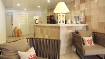 A reception area with a counter, two armchairs, and a lamp.