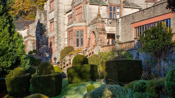 A historic stone building with a formal garden, including topiary and a fountain. - Netherwood Hotel & Spa (Grange-over-Sands)
