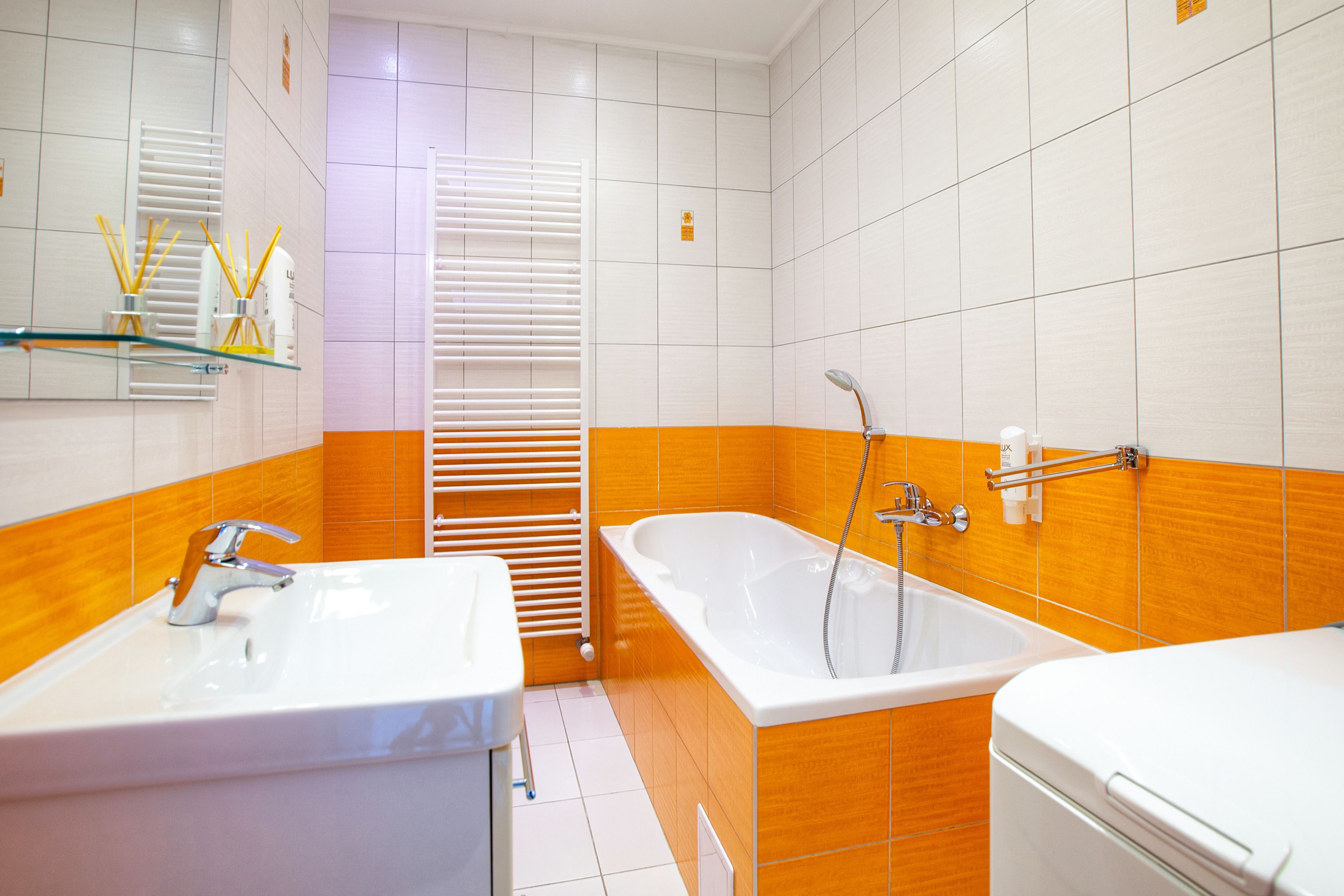 A bathroom with a white sink, a bathtub, and a toilet.